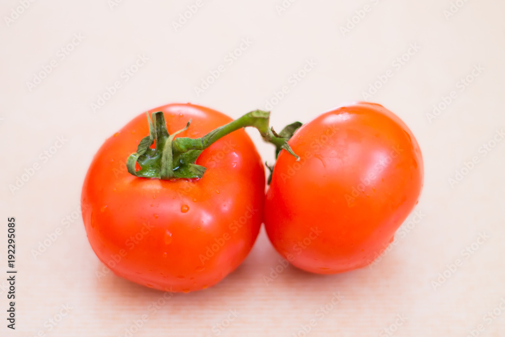 Two red tomatoes with water drops. Fresh vegetables for a healthy diet Two red tomatoes with water drops. Fresh vegetables for a healthy diet
