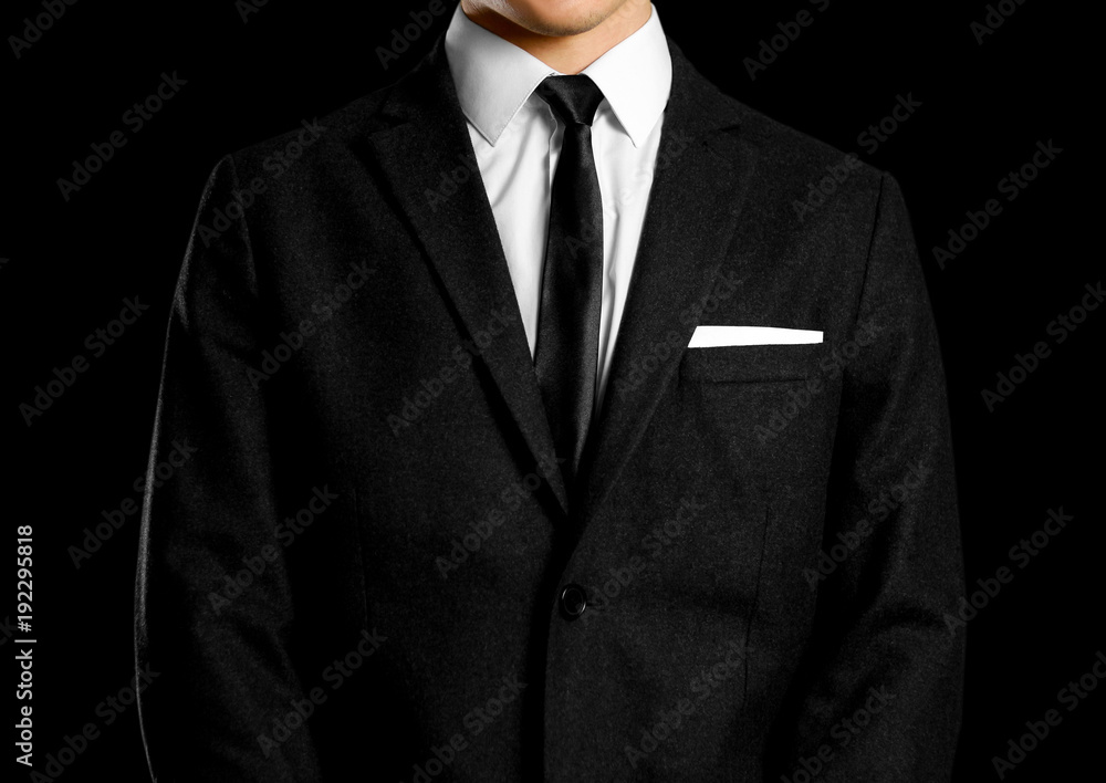 Businessman in a black suit, white shirt and tie. Studio shooting Businessman in a black suit, white shirt and tie. Studio shooting