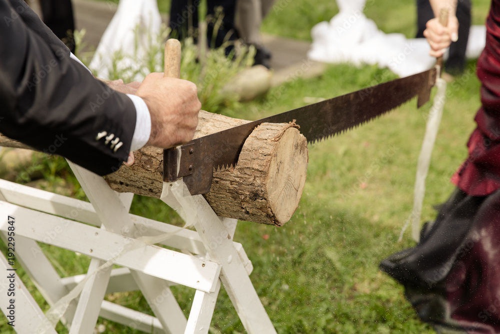 Baumstamm sägen auf Hochzeit StockFoto Adobe Stock
