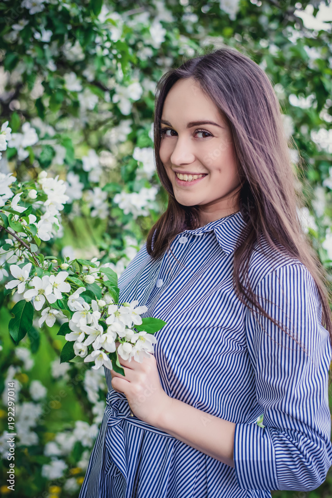 Beautiful girl near blooming Apple trees in spring Beautiful girl near blooming Apple trees in spring
