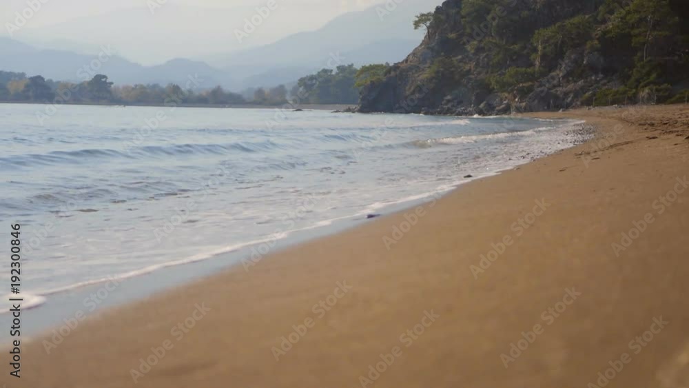 Sea wave splash on sandy beach in autumn day Sea wave splash on sandy beach in autumn day