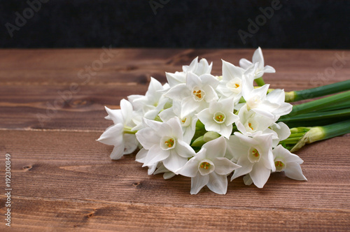 Fototapeta Naklejka Na Ścianę i Meble -  Freshly cut bunch of white narcissi on a wooden table