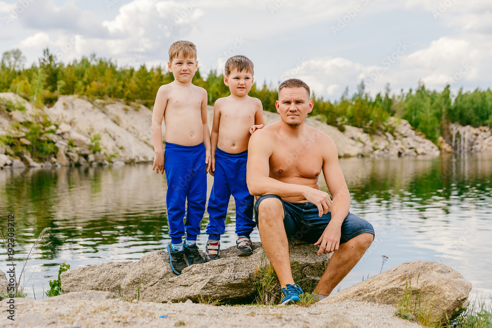 father and his two sons shirtless on the shore of the pond summer Stock Photo Adobe Stock