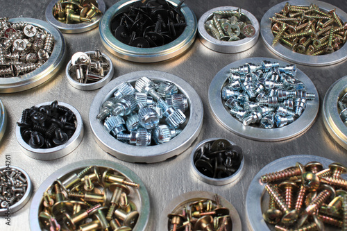 Screws, bolts and nuts on metal background photo