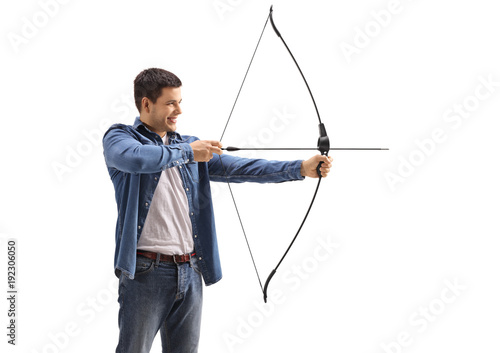 Young man aiming with a bow and arrow