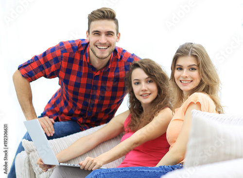 portrait of a group of young people sitting on the couch in the living room.