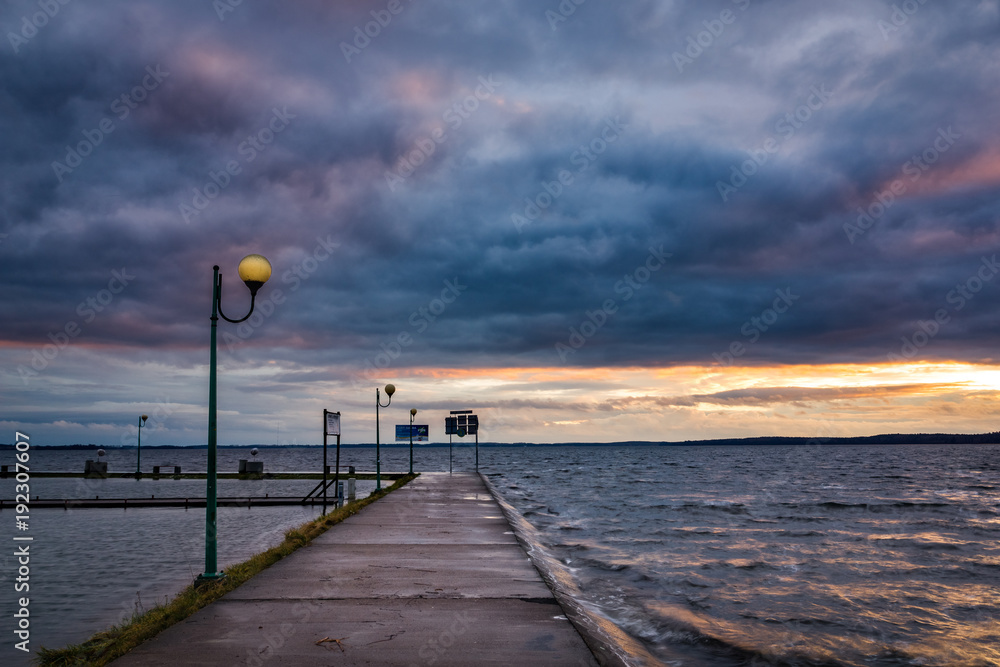 Storm clouds over the pier at the Niegocin lake in Gizycko, Masuria, Poland