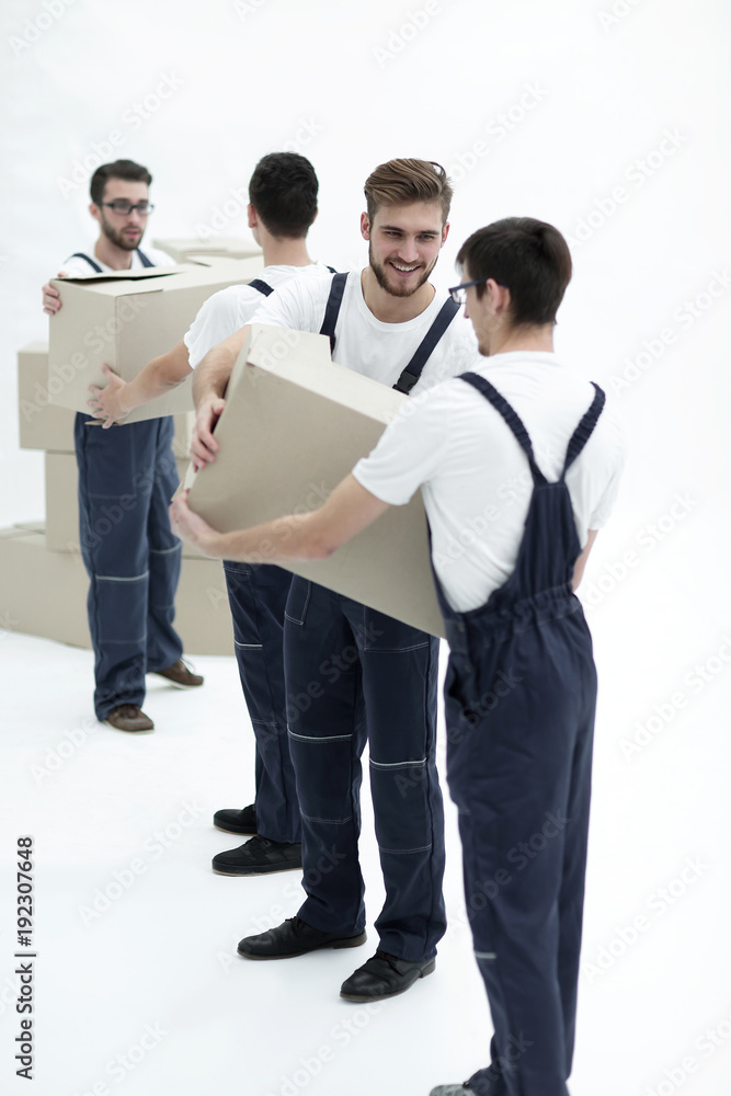 Photo workers pass each other boxes when moving flats. Photo workers pass each other boxes when moving flats.