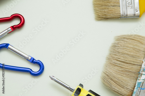 Home, House Repair, Redecorating, Renovating Concept. A set of repair tools on a white grid: a screwdriver and paint brushes, top view, flat lay photo