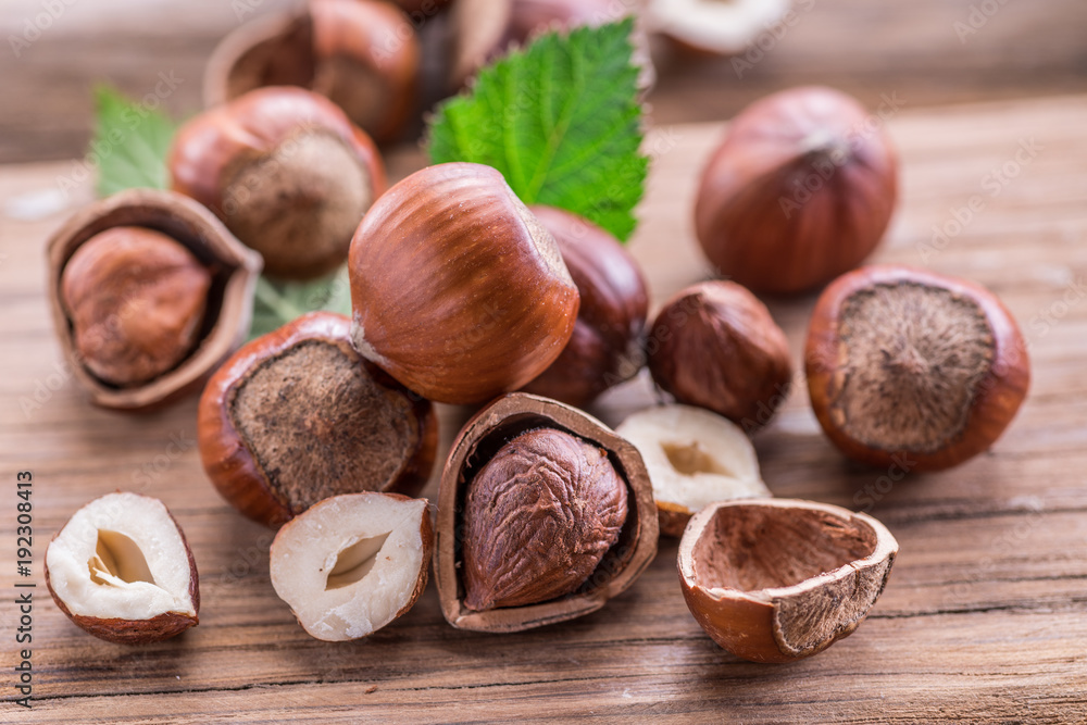 Hazelnuts and hazelnut leaves on the wooden table. Hazelnuts and hazelnut leaves on the wooden table.