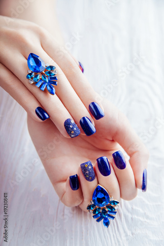 Blue manicure on white background