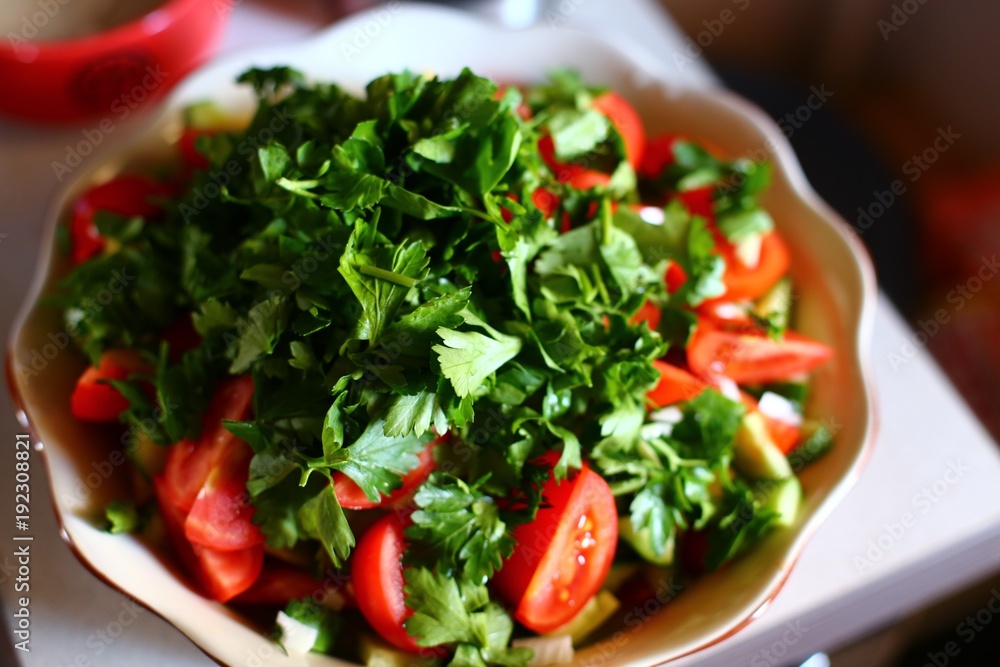 Healthy vegetarian Salad on the white plate. tomato and parsley salad top view Healthy vegetarian Salad on the white plate. tomato and parsley salad top view