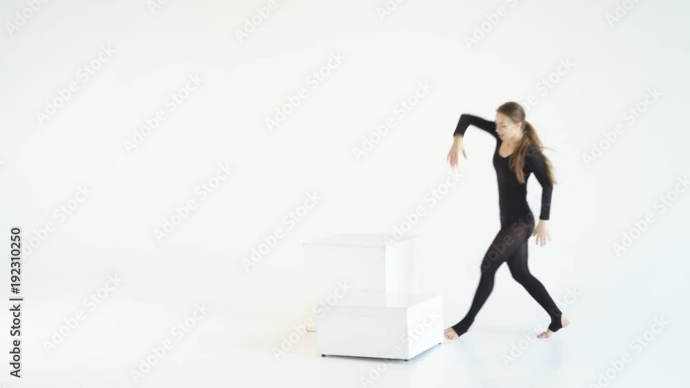 young blonde woman dancing on isolated white background. Staging emotional choreography. a lot of expression in the movements. dance on a white cube in a cycramrame 4k young blonde woman dancing on isolated white background. Staging emotional choreography. a lot of expression in the movements. dance on a white cube in a cycramrame 4k