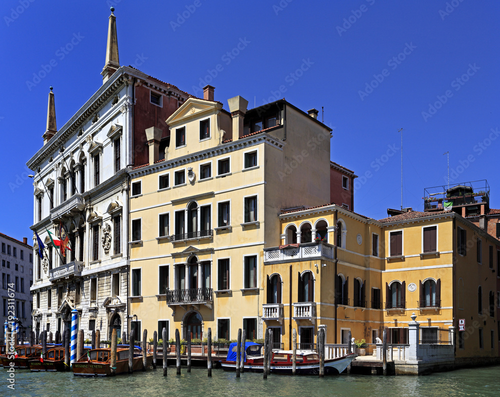 Venice historic city center, Veneto rigion, Italy - view on the Palazzo residences with vaporetto water taxis and gondolas on the Grand Canal