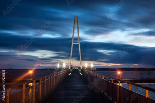 Fototapeta Naklejka Na Ścianę i Meble -  Pier at the Niegocin lake and rainy clouds at night in Gizycko, Masuria, Poland