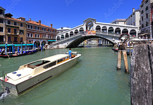 Venice historic city center, Veneto rigion, Italy - view on the Rialto Bridge with vaporetto water taxis and gondolas on the Grand Canal © Art Media Factory