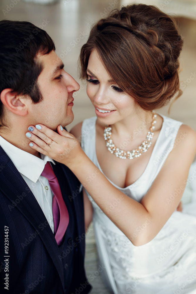 Groom and bride posing and smiling in studio for wedding shot. Wedding. Wedding day. Beautiful bride and elegant groom after wedding ceremony. Groom and bride posing and smiling in studio for wedding shot. Wedding. Wedding day. Beautiful bride and elegant groom after wedding ceremony.