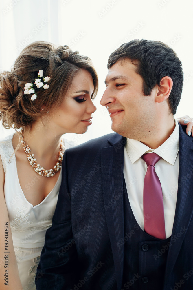 Groom and bride posing and smiling in studio for wedding shot. Wedding. Wedding day. Beautiful bride and elegant groom after wedding ceremony. Groom and bride posing and smiling in studio for wedding shot. Wedding. Wedding day. Beautiful bride and elegant groom after wedding ceremony.