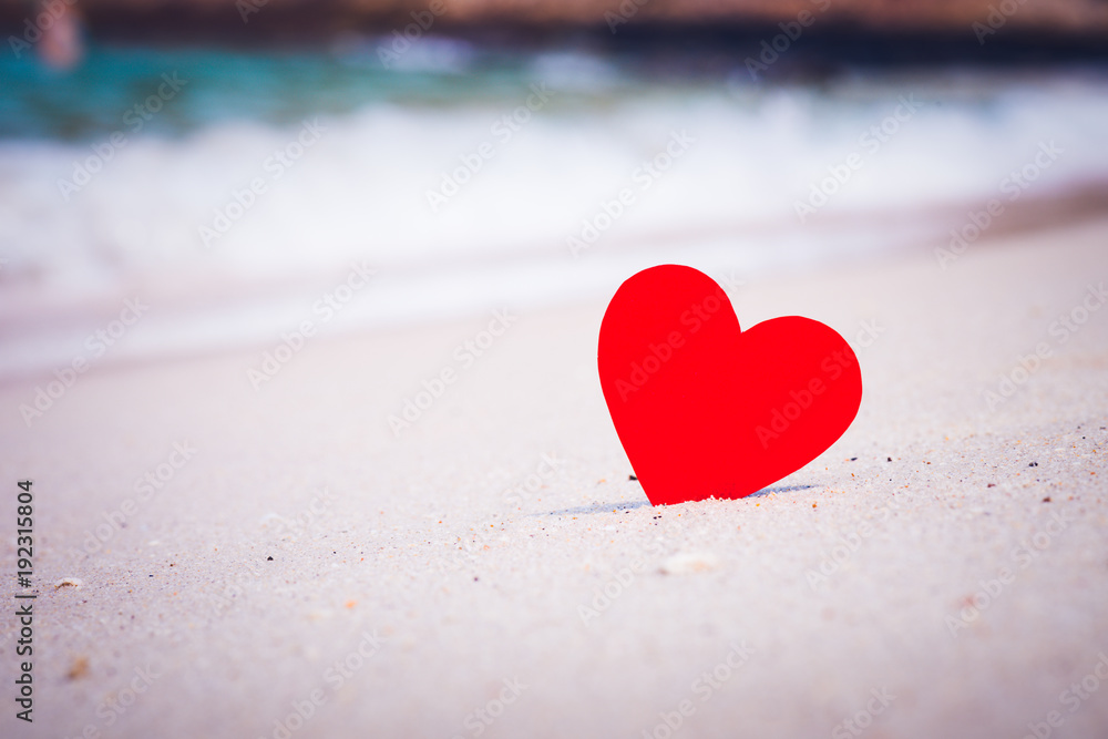 Fototapeta premium Two red hearts on the summer beach. Love, Wedding and Valentines day concept.