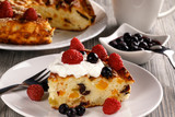 The cottage cheese casserole decorated with fresh blueberries and raspberry.Close up.
