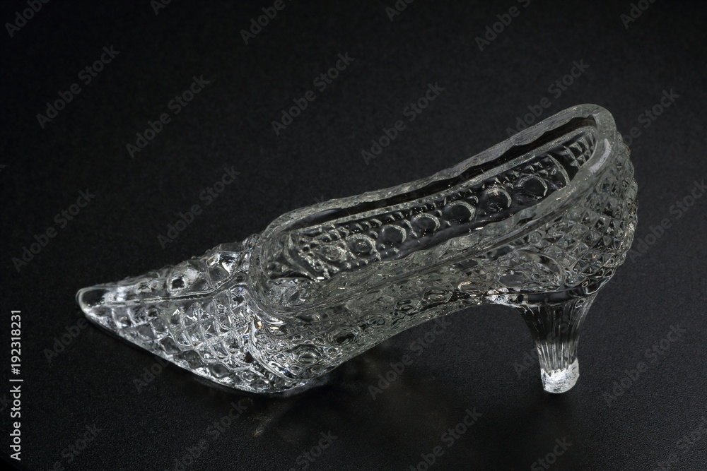Crystal Cinderella Shoe on a dark background. Decorative accessory Crystal Cinderella Shoe on a dark background. Decorative accessory