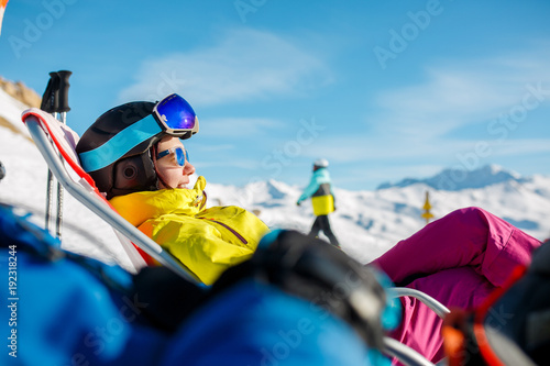 Canvas Print Picture of smiling sportswoman lying on winter deckchair