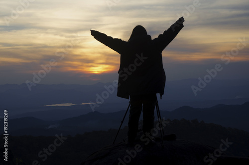 Silhouet is photographed on a hilltop.