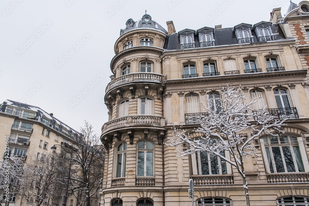 Paris under the snow, beautiful facades in winter
