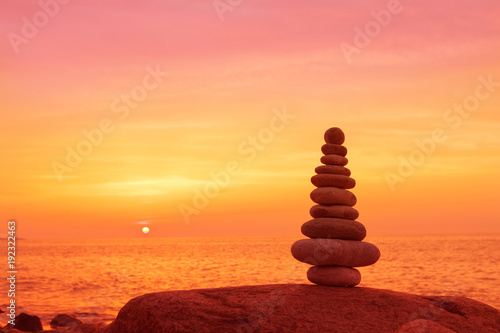 Stones balance on a background of sea sunset. Concept of harmony and balance
