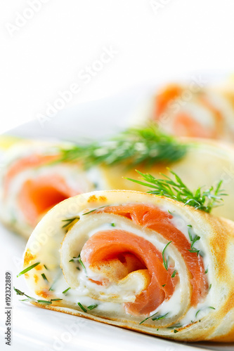 Pancakes with fish salmon, cheese and dill. Macro. Space for text