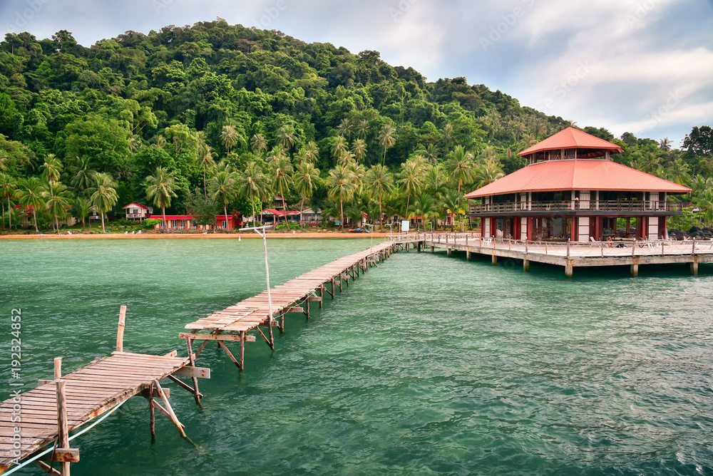 wooden bridge on sea straight to seashore