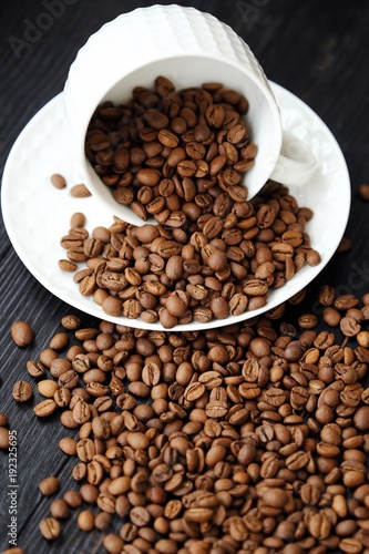 Fototapeta Naklejka Na Ścianę i Meble -  Roasted coffee beans in white mug on table  