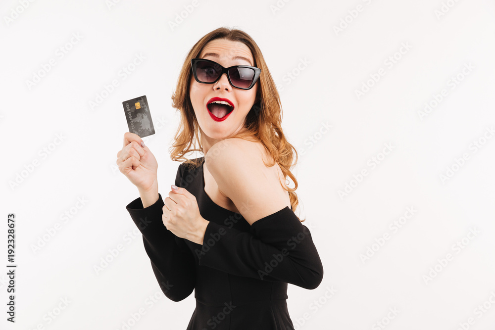 Portrait of an excited young woman dressed in black dress