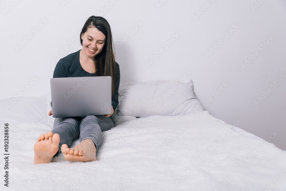 woman sit on the bed and use her laptop woman sit on the bed and use her laptop
