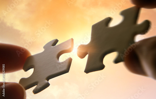 Konstfotografi Putting puzzle pieces together on sky background with sunlight
