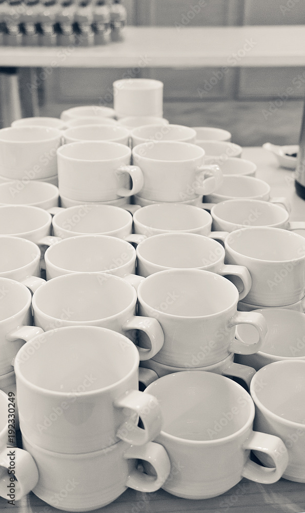 A lot of empty white porcelain cups on a table