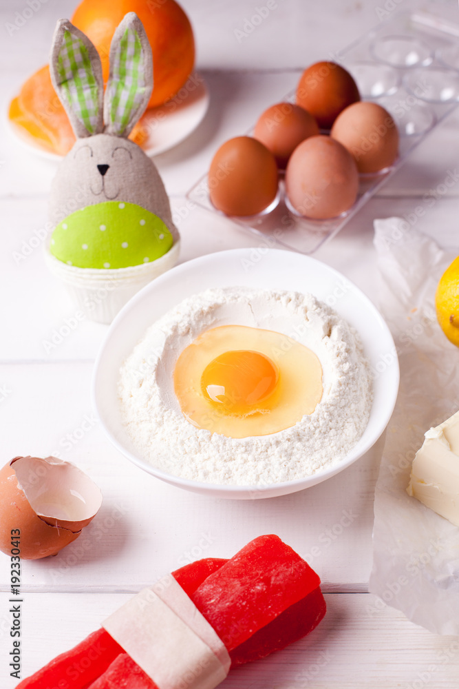 set of ingredients for easter baking and easter bunny on a white background set of ingredients for easter baking and easter bunny on a white background
