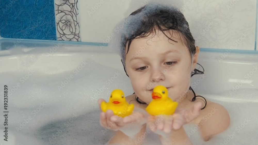 Child in the bathroom. Little girl is playing in the bathroom. Child in the bathroom. Little girl is playing in the bathroom.