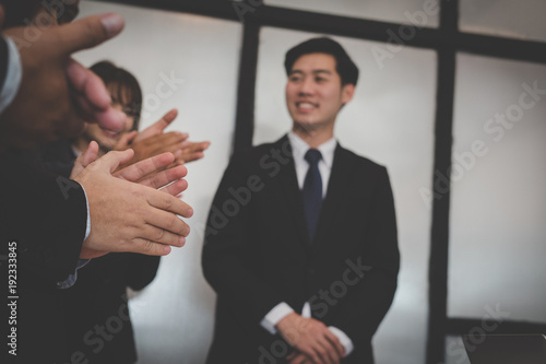 Fototapeta Naklejka Na Ścianę i Meble -  cheerful businessman applauding at conference. successful business team clapping hands for great work