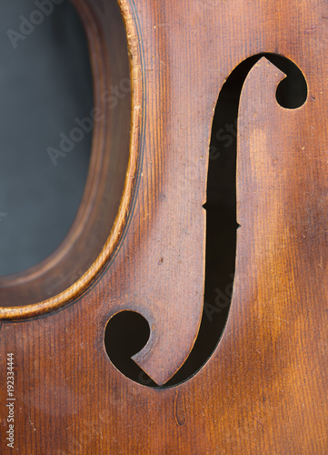 closeup of old double bass with f hole in resonance box