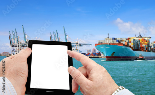 Close up of businessman using smart phone for logistic business on cargo ship background