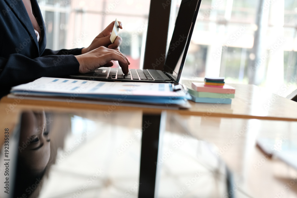 woman holding a credit card and using computer for online shopping at cafe. businesswoman purchase goods from internet at office. female startup make payment on bank website at workplace woman holding a credit card and using computer for online shopping at cafe. businesswoman purchase goods from internet at office. female startup make payment on bank website at workplace