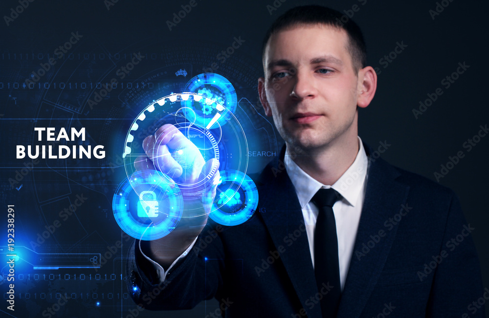 Business, Technology, Internet and network concept. Young businessman working on a virtual screen of the future and sees the inscription: Team building Business, Technology, Internet and network concept. Young businessman working on a virtual screen of the future and sees the inscription: Team building