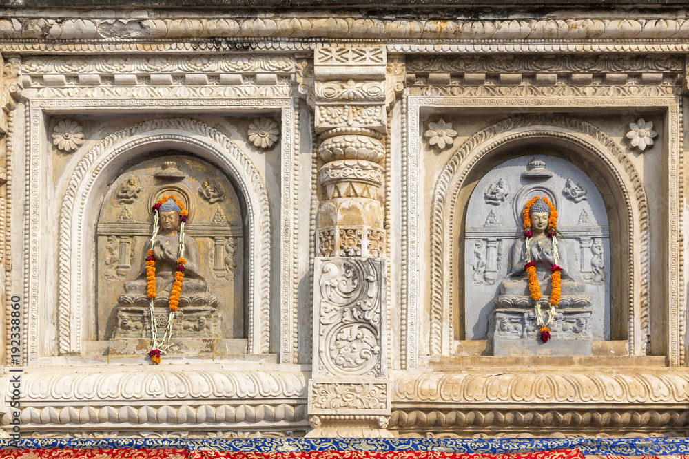 architectural detail with Buddha sculptures at the Mahabodhi Temple, Bodhgaya, Bihar, India