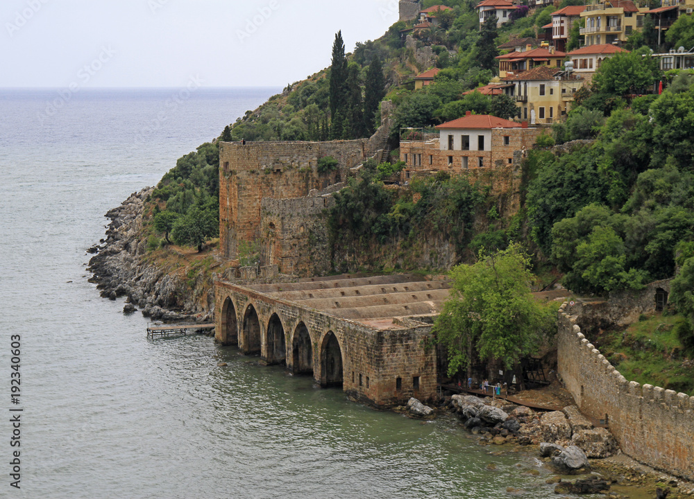 Shipyard and the ruins of a medieval fortress Shipyard and the ruins of a medieval fortress