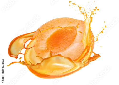 half of apricot in juice splash isolated on a white background