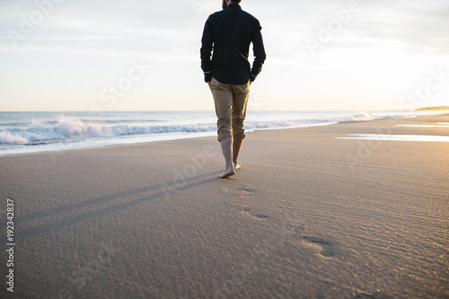 walking on beach at sunset