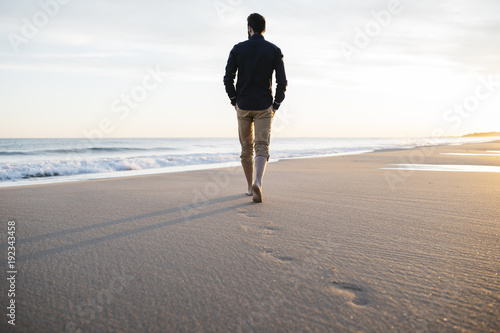 walking on beach at sunset