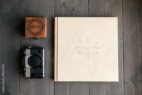 White leather wedding album, wooden box with inscription Wedding day and vintage photo camera