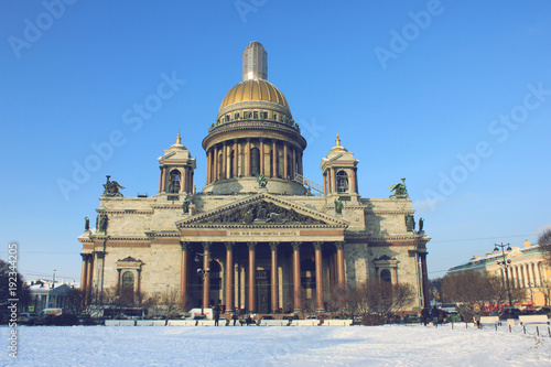 Saint Isaac's Cathedral Winter View in St. Petersburg, Russia. Famous City Symbol Landmark on Cold Sunny Day. Outdoor Scenic Park Nature with Snow and Clear Blue Sky Background with No People Around.